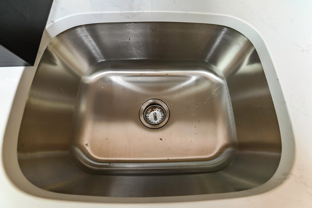 Light Cream Kitchen Corner with Quartz Countertops and Marble Top Island