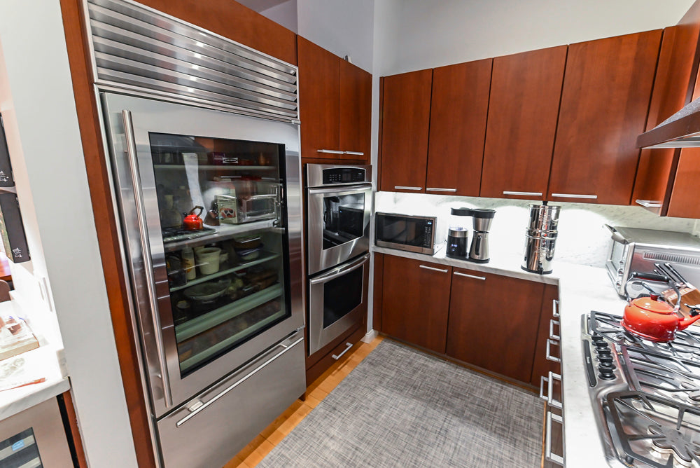 Poggenpohl Brown Toned Transitional Kitchen with Marble Countertops and Appliances