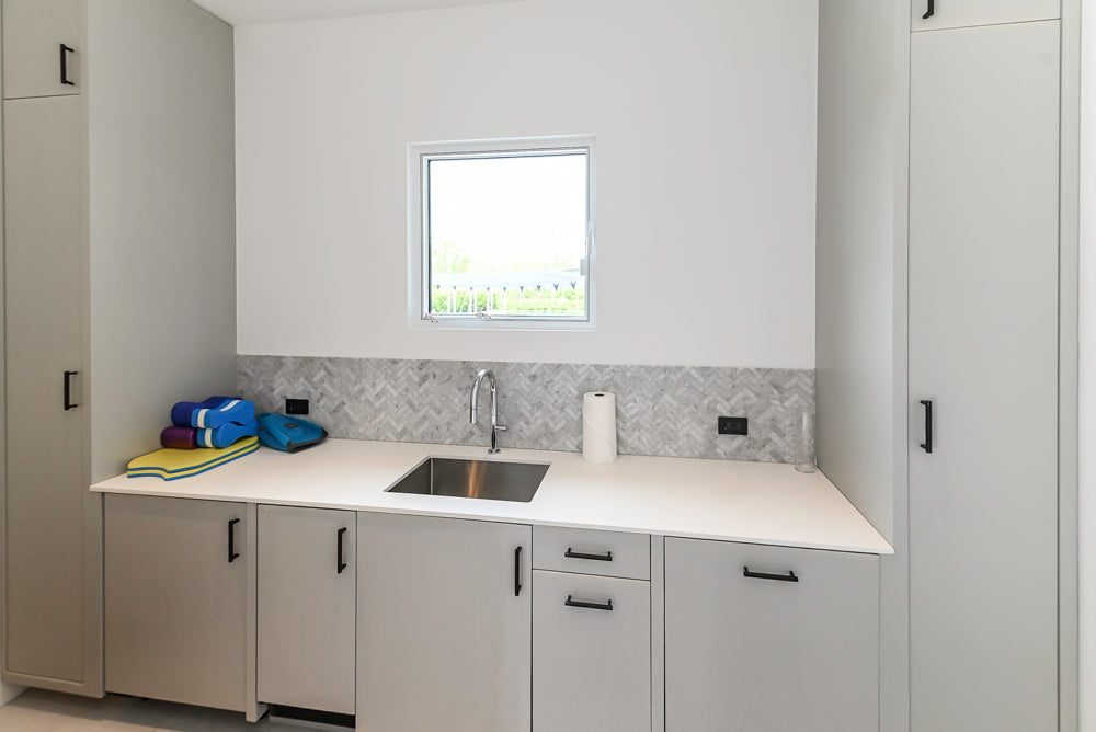 Custom Modern Light Grey Pantry with White Stone Countertops and Stainless Steel Sink