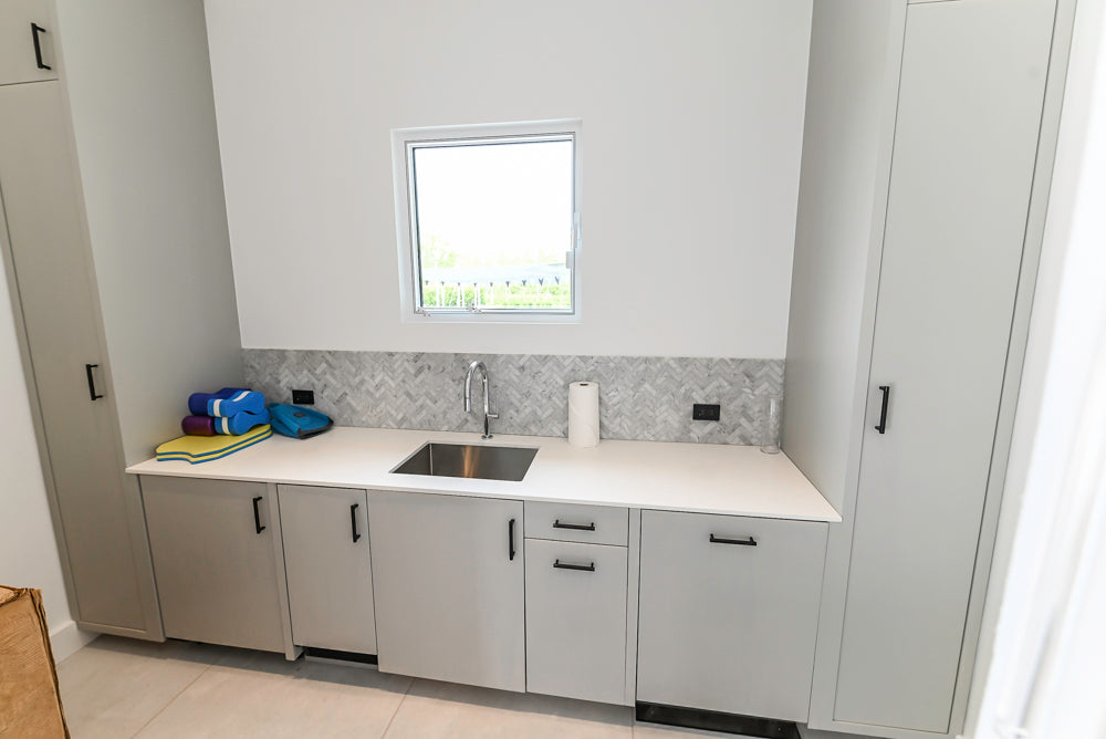 Custom Modern Light Grey Pantry with White Stone Countertops and Stainless Steel Sink