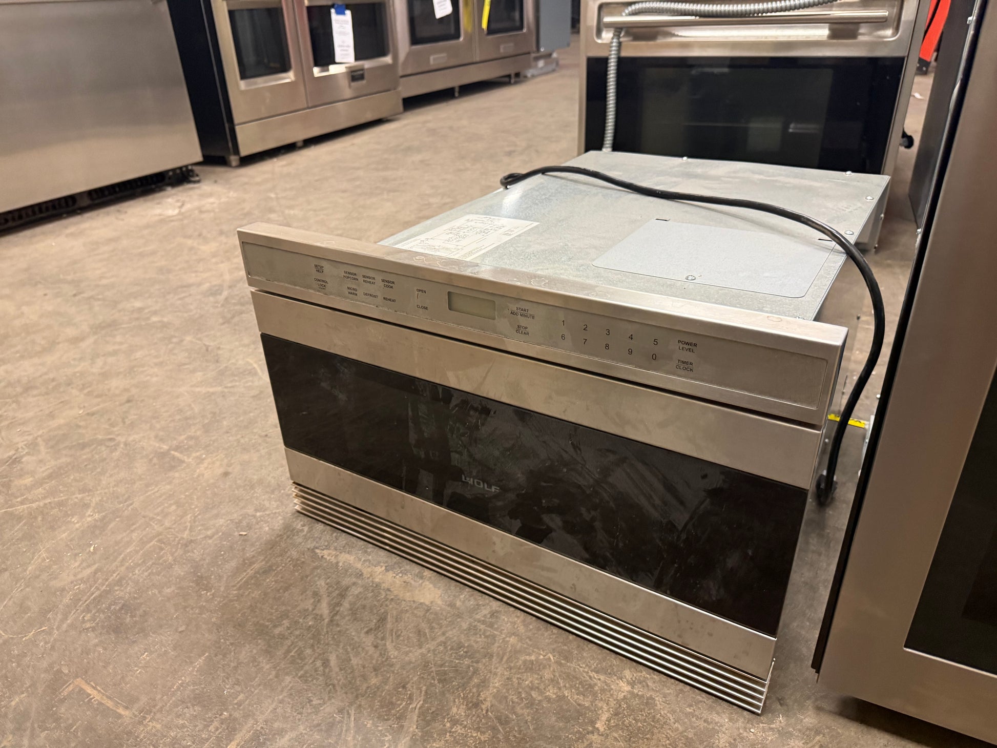 Stainless steel Wolf MWD242US microwave drawer installed flush in cabinetry