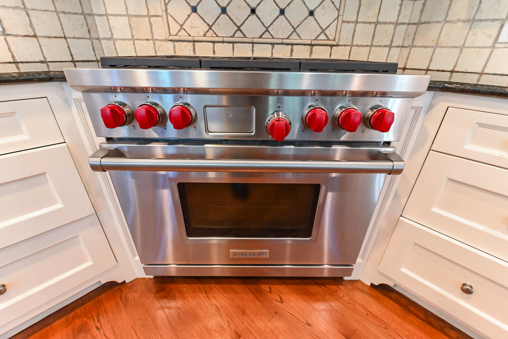 Custom Traditional White Kitchen with Wood Island, Granite Countertops and Wolf Range