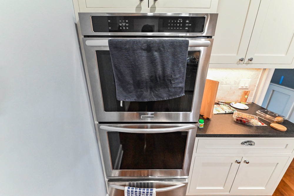 Custom Traditional White Kitchen with Stone Countertops and Appliances