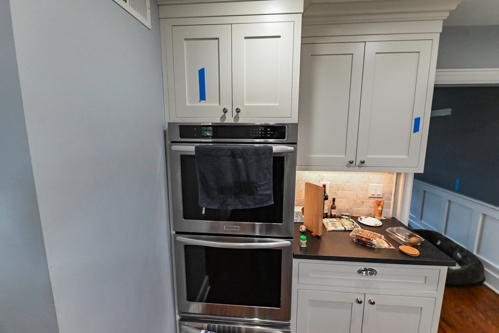 Custom Traditional White Kitchen with Stone Countertops and Appliances