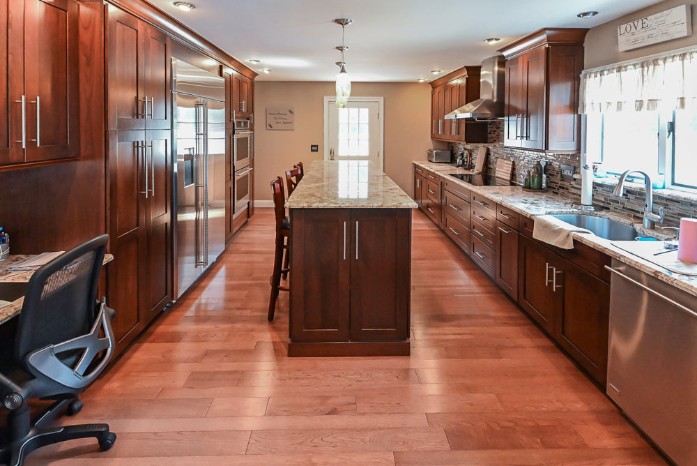 Kraftmaid Transitional Dark Wooden Kitchen with Marble Countertops and GE Monogram Appliances