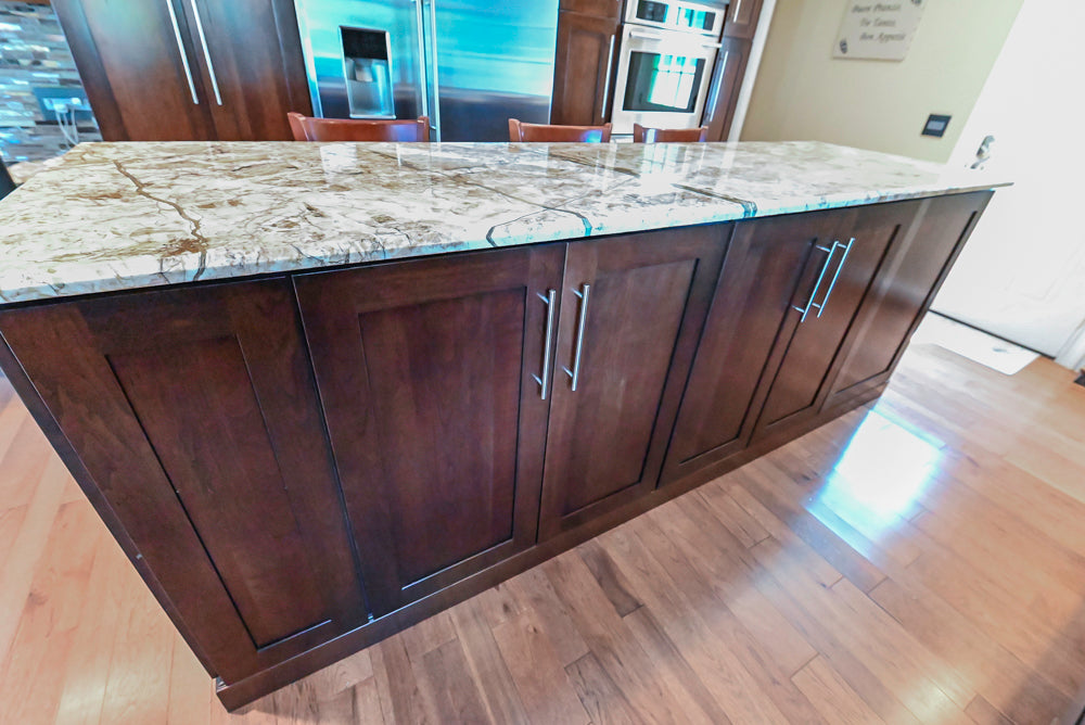 Kraftmaid Transitional Dark Wooden Kitchen with Marble Countertops and GE Monogram Appliances