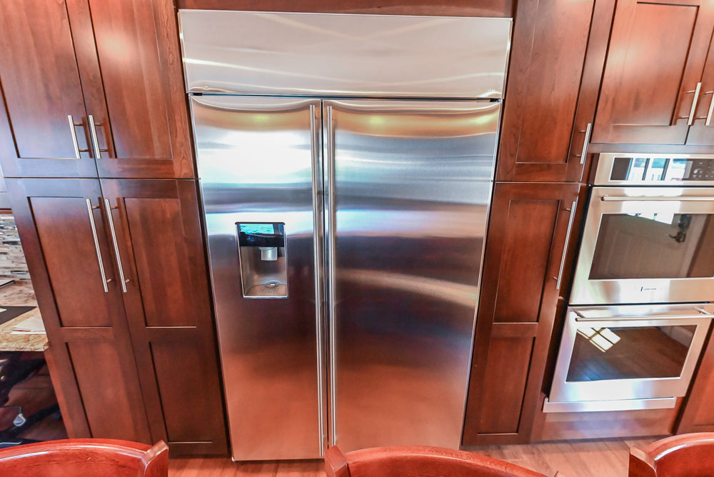 Kraftmaid Transitional Dark Wooden Kitchen with Marble Countertops and GE Monogram Appliances