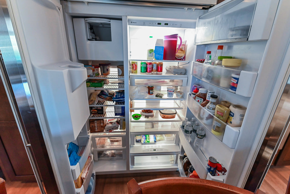 Kraftmaid Transitional Dark Wooden Kitchen with Marble Countertops and GE Monogram Appliances