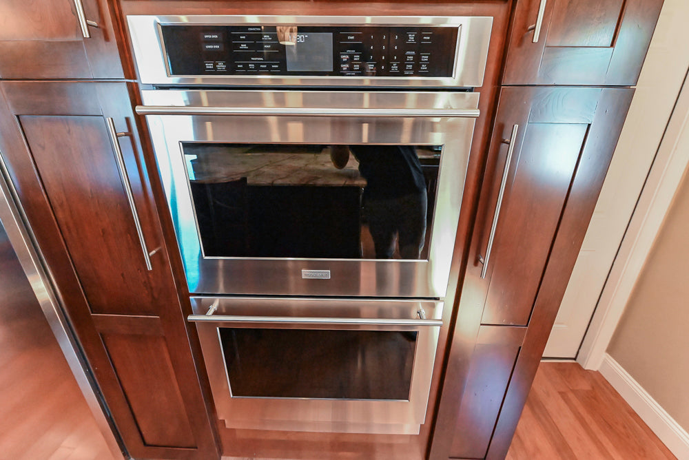 Kraftmaid Transitional Dark Wooden Kitchen with Marble Countertops and GE Monogram Appliances