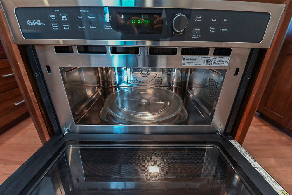 Kraftmaid Transitional Dark Wooden Kitchen with Marble Countertops and GE Monogram Appliances