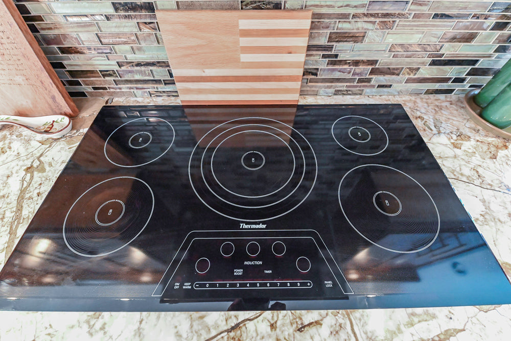 Kraftmaid Transitional Dark Wooden Kitchen with Marble Countertops and GE Monogram Appliances