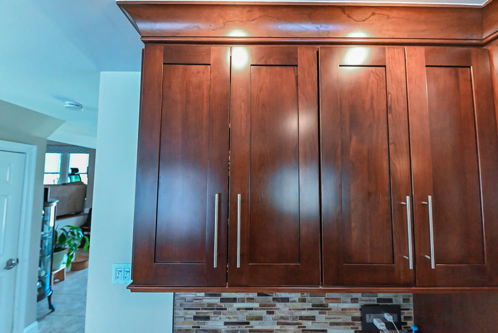 Kraftmaid Transitional Dark Wooden Kitchen with Marble Countertops and GE Monogram Appliances
