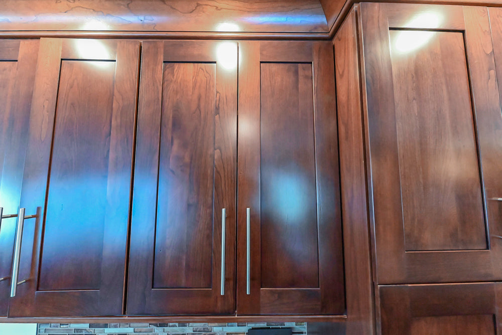 Kraftmaid Transitional Dark Wooden Kitchen with Marble Countertops and GE Monogram Appliances