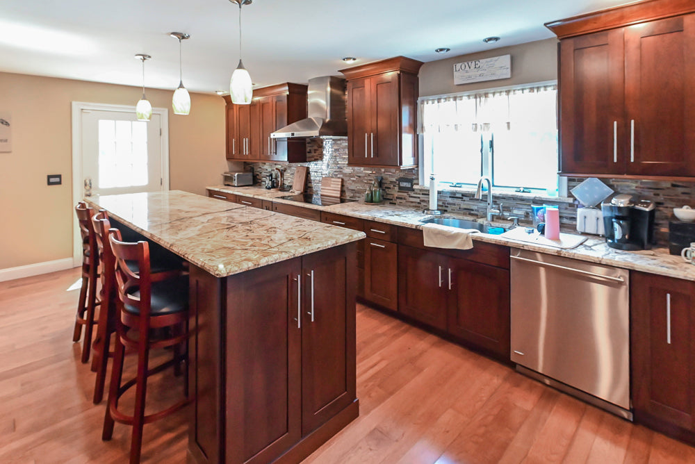 Kraftmaid Transitional Dark Wooden Kitchen with Marble Countertops and GE Monogram Appliances