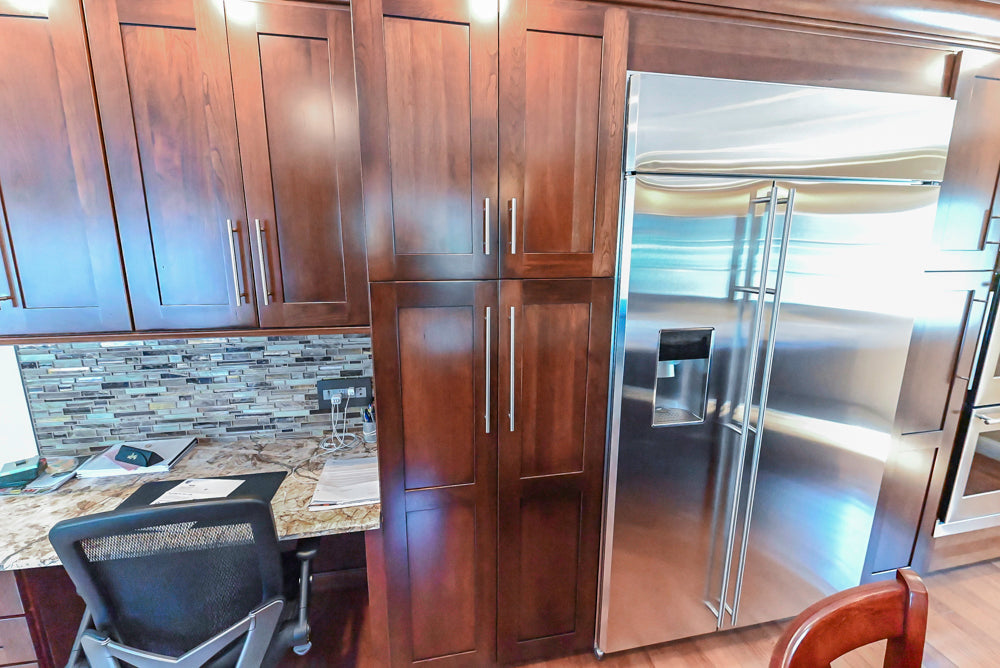 Kraftmaid Transitional Dark Wooden Kitchen with Marble Countertops and GE Monogram Appliances