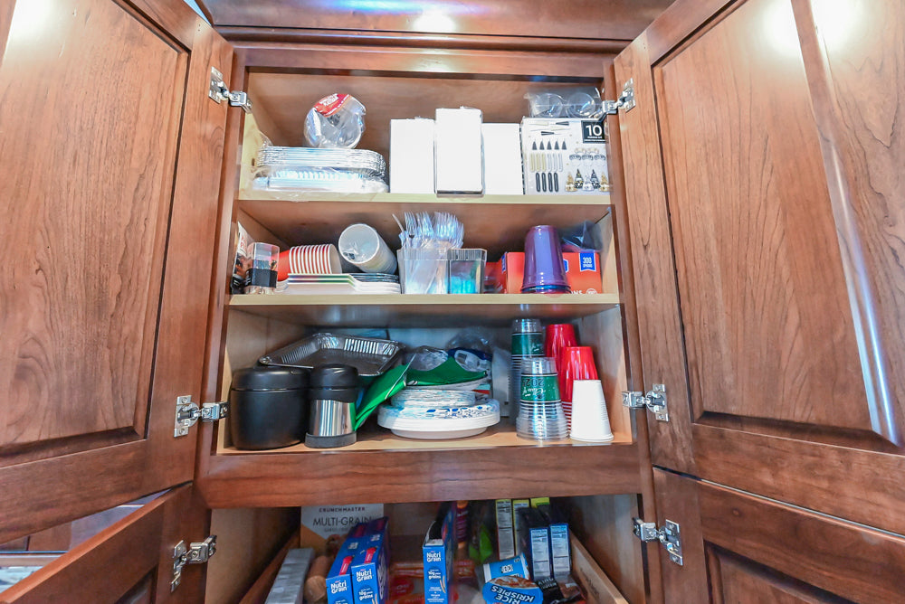 Kraftmaid Transitional Dark Wooden Kitchen with Marble Countertops and GE Monogram Appliances