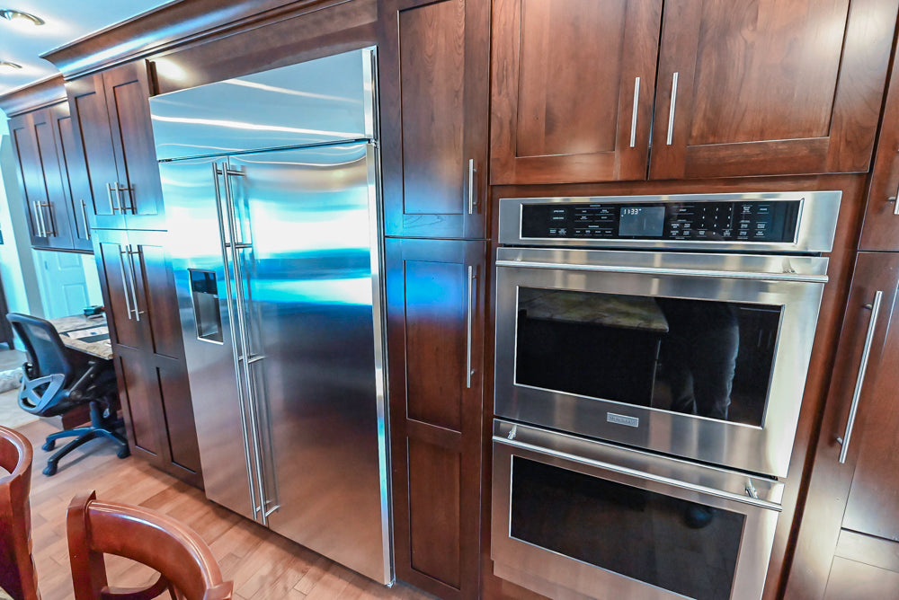 Kraftmaid Transitional Dark Wooden Kitchen with Marble Countertops and GE Monogram Appliances