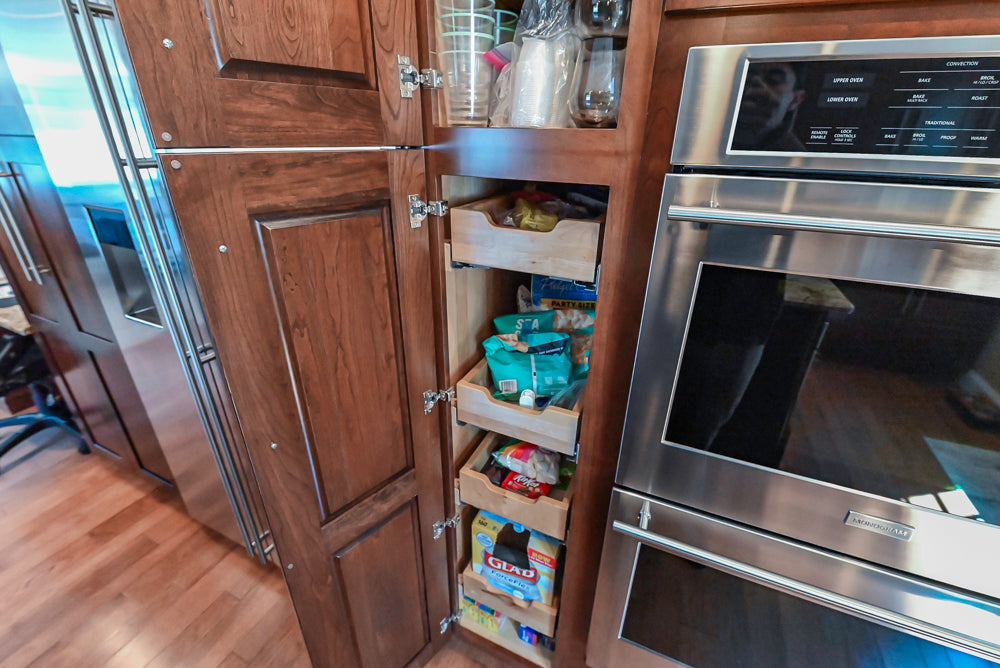 Kraftmaid Transitional Dark Wooden Kitchen with Marble Countertops and GE Monogram Appliances