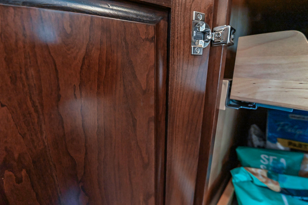 Kraftmaid Transitional Dark Wooden Kitchen with Marble Countertops and GE Monogram Appliances