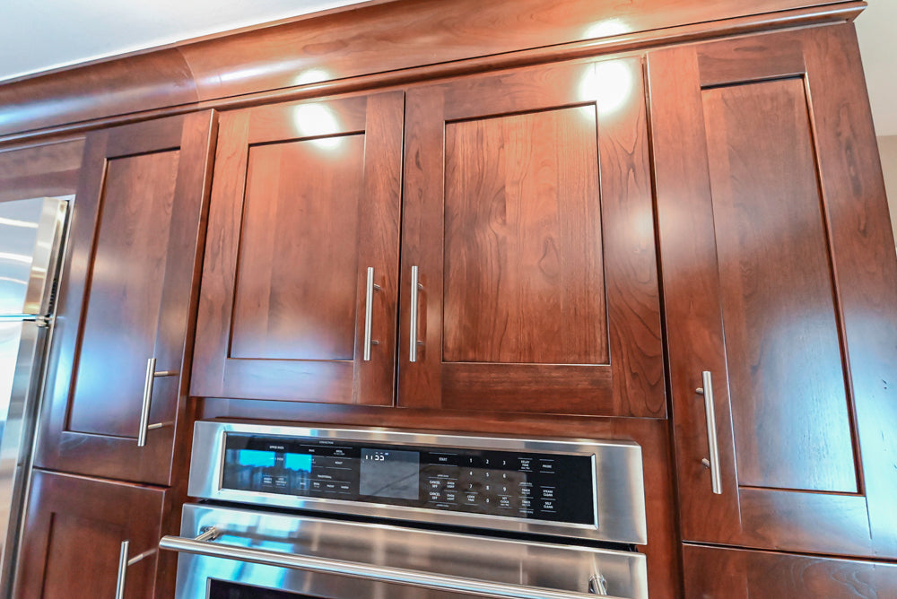 Kraftmaid Transitional Dark Wooden Kitchen with Marble Countertops and GE Monogram Appliances