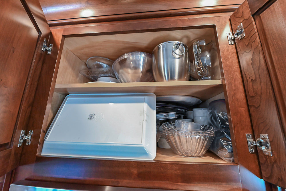 Kraftmaid Transitional Dark Wooden Kitchen with Marble Countertops and GE Monogram Appliances