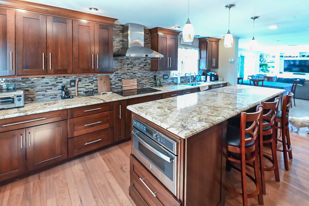 Kraftmaid Transitional Dark Wooden Kitchen with Marble Countertops and GE Monogram Appliances