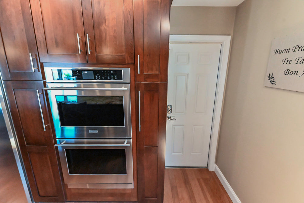 Kraftmaid Transitional Dark Wooden Kitchen with Marble Countertops and GE Monogram Appliances