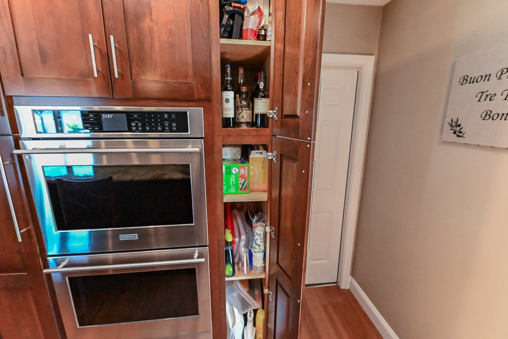 Kraftmaid Transitional Dark Wooden Kitchen with Marble Countertops and GE Monogram Appliances