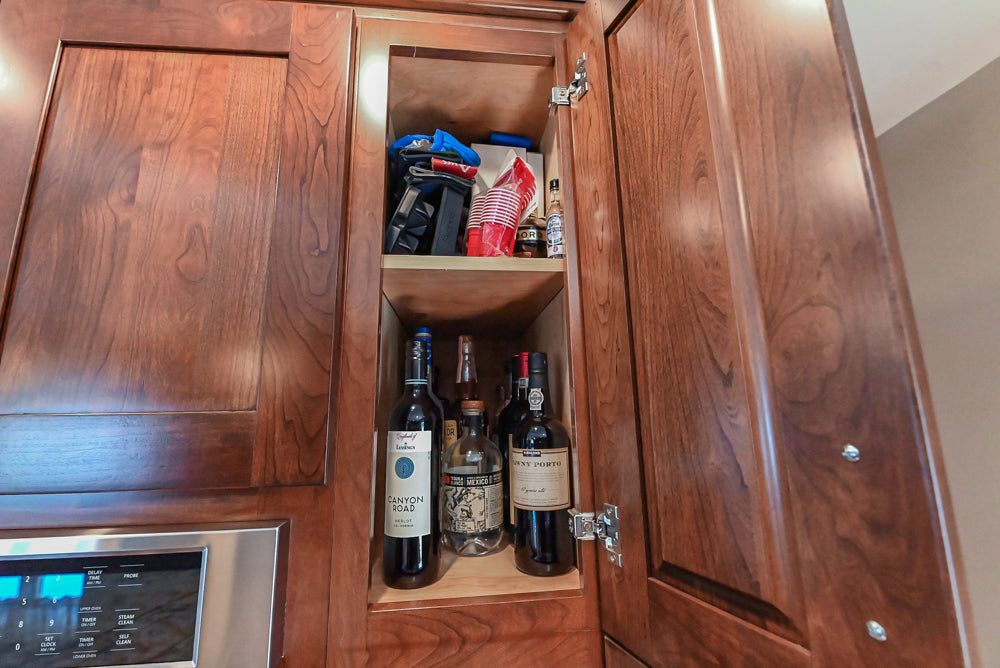 Kraftmaid Transitional Dark Wooden Kitchen with Marble Countertops and GE Monogram Appliances