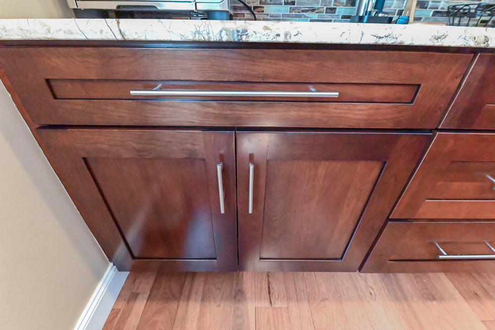 Kraftmaid Transitional Dark Wooden Kitchen with Marble Countertops and GE Monogram Appliances