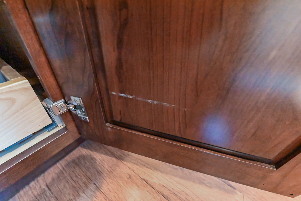 Kraftmaid Transitional Dark Wooden Kitchen with Marble Countertops and GE Monogram Appliances