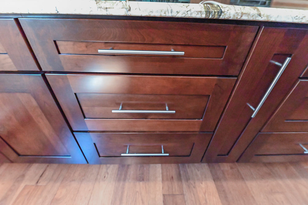 Kraftmaid Transitional Dark Wooden Kitchen with Marble Countertops and GE Monogram Appliances