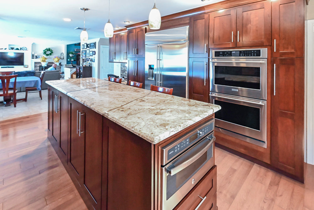 Kraftmaid Transitional Dark Wooden Kitchen with Marble Countertops and GE Monogram Appliances