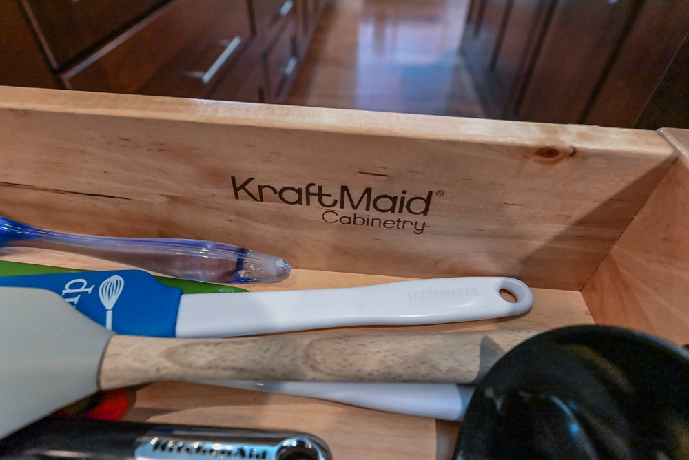 Kraftmaid Transitional Dark Wooden Kitchen with Marble Countertops and GE Monogram Appliances