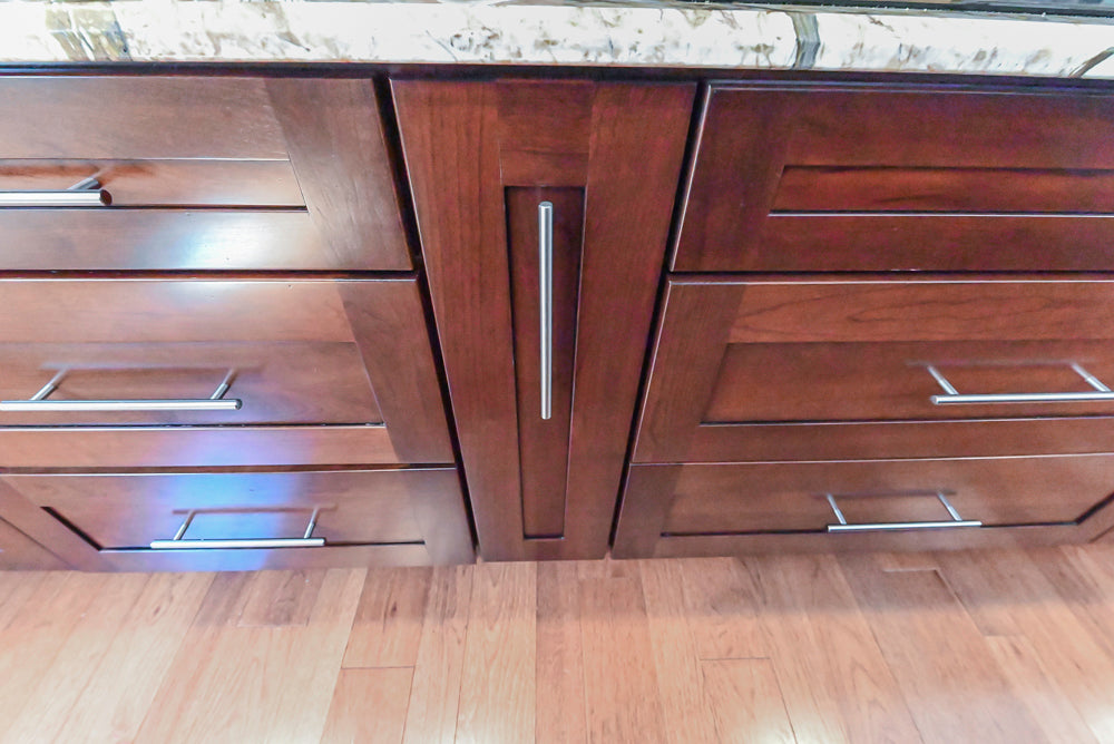 Kraftmaid Transitional Dark Wooden Kitchen with Marble Countertops and GE Monogram Appliances