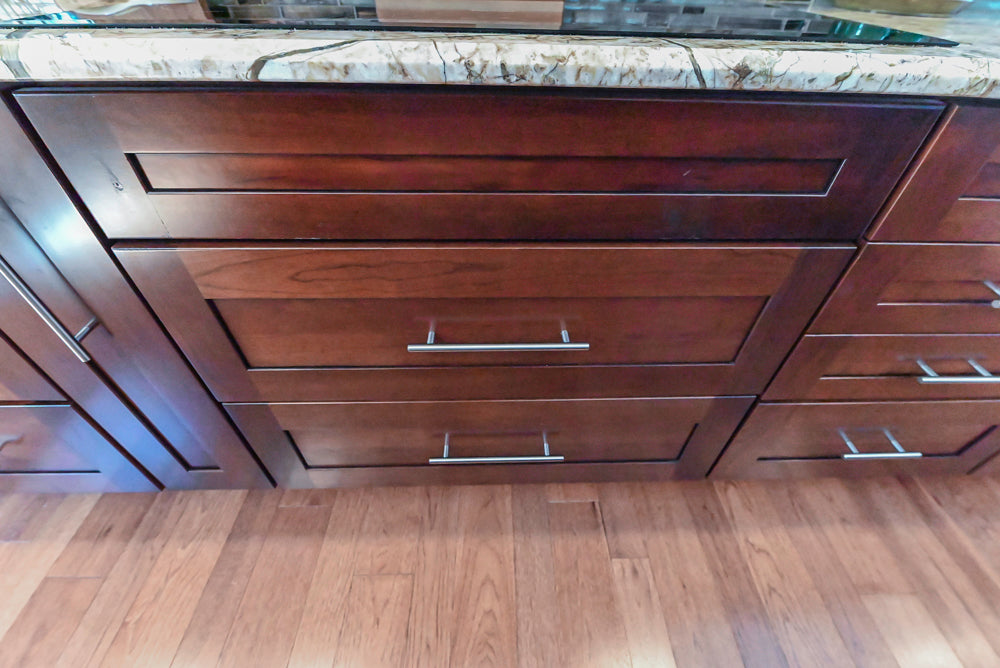 Kraftmaid Transitional Dark Wooden Kitchen with Marble Countertops and GE Monogram Appliances