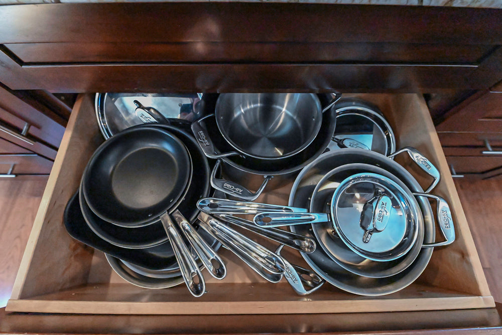 Kraftmaid Transitional Dark Wooden Kitchen with Marble Countertops and GE Monogram Appliances