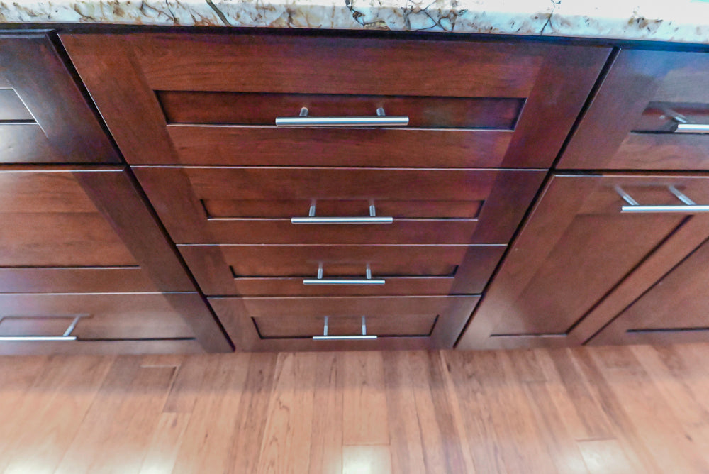 Kraftmaid Transitional Dark Wooden Kitchen with Marble Countertops and GE Monogram Appliances