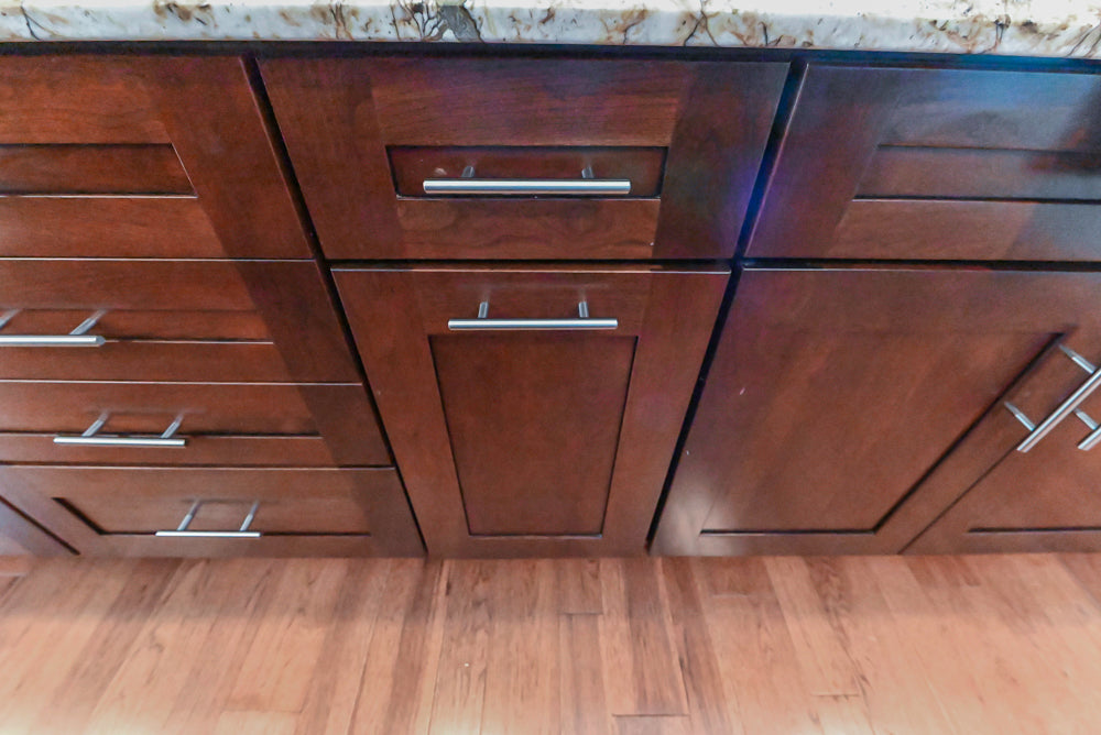 Kraftmaid Transitional Dark Wooden Kitchen with Marble Countertops and GE Monogram Appliances