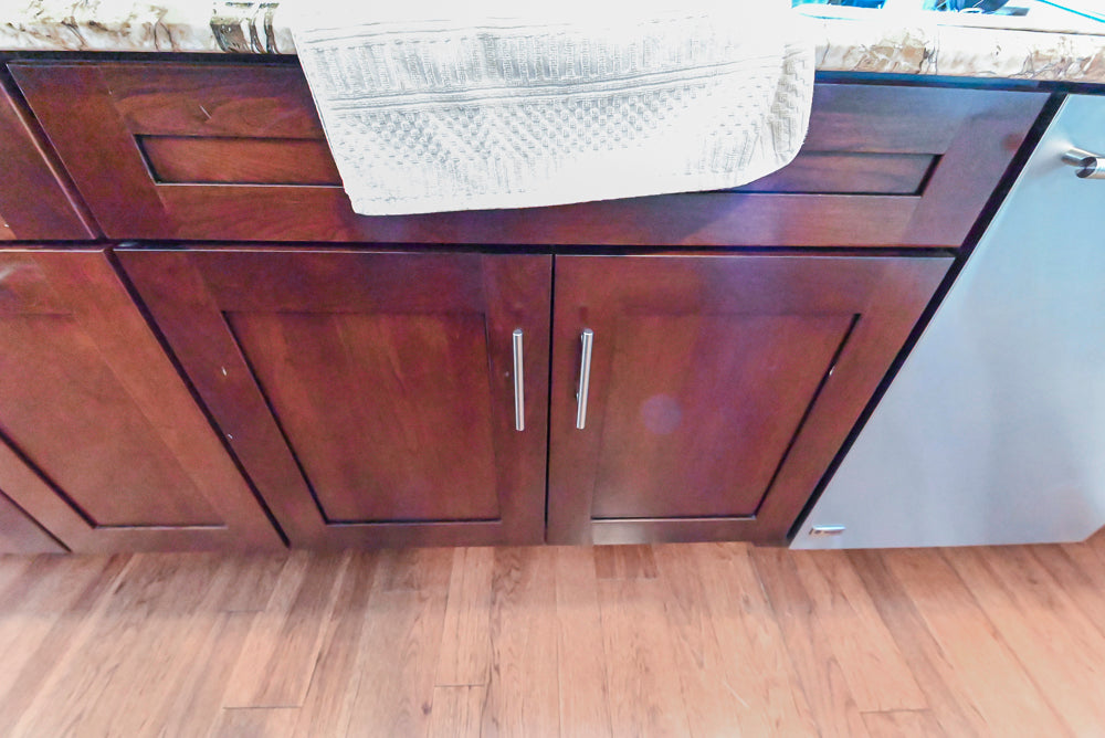 Kraftmaid Transitional Dark Wooden Kitchen with Marble Countertops and GE Monogram Appliances
