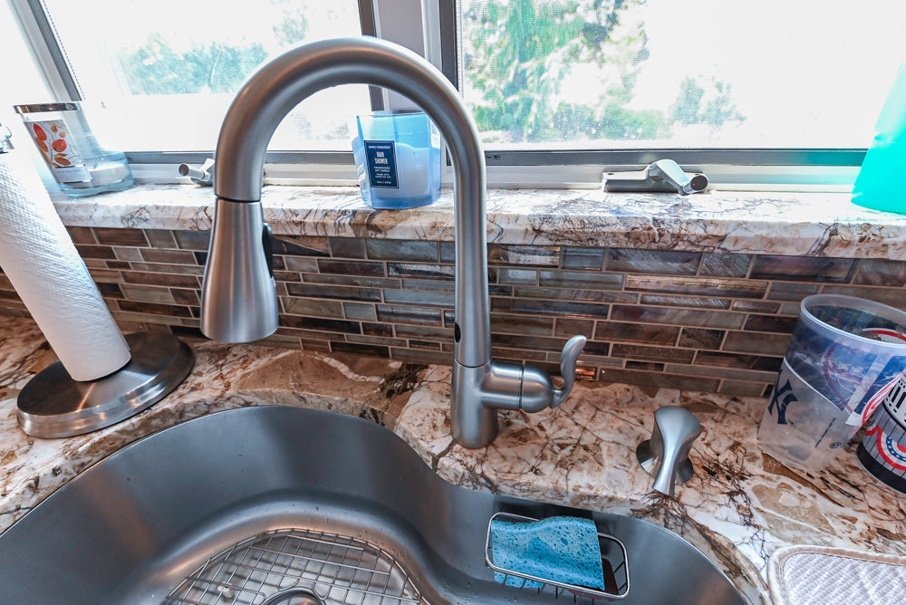 Kraftmaid Transitional Dark Wooden Kitchen with Marble Countertops and GE Monogram Appliances