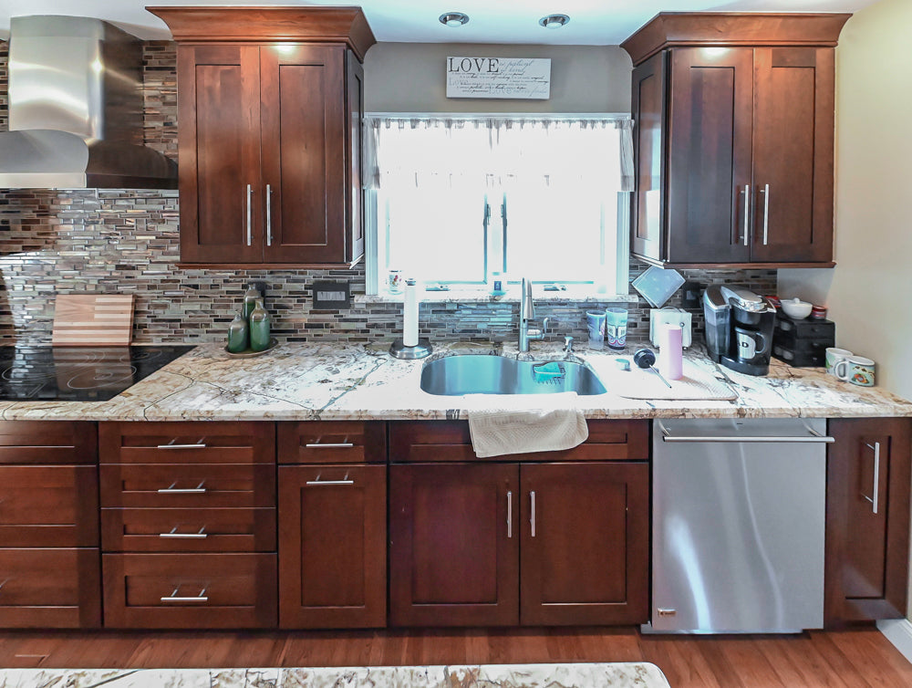 Kraftmaid Transitional Dark Wooden Kitchen with Marble Countertops and GE Monogram Appliances