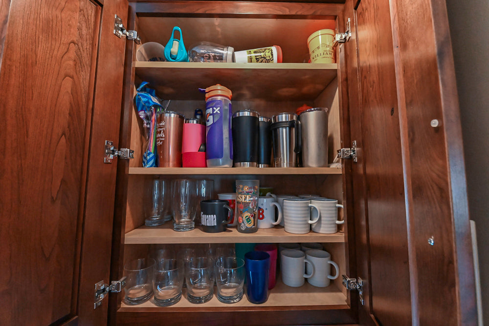 Kraftmaid Transitional Dark Wooden Kitchen with Marble Countertops and GE Monogram Appliances