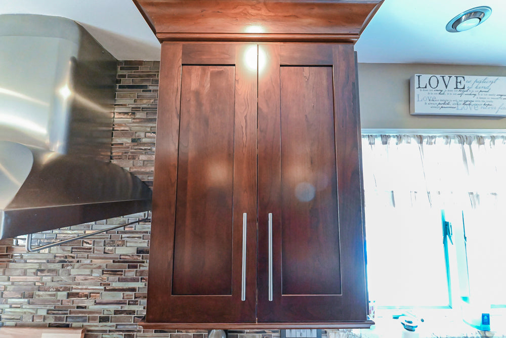 Kraftmaid Transitional Dark Wooden Kitchen with Marble Countertops and GE Monogram Appliances