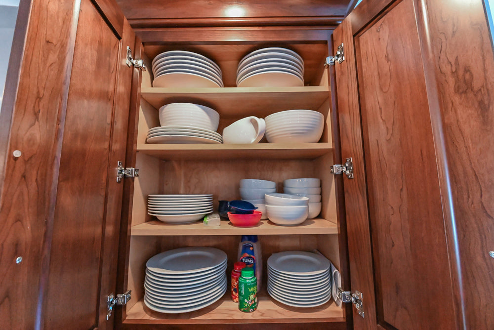 Kraftmaid Transitional Dark Wooden Kitchen with Marble Countertops and GE Monogram Appliances
