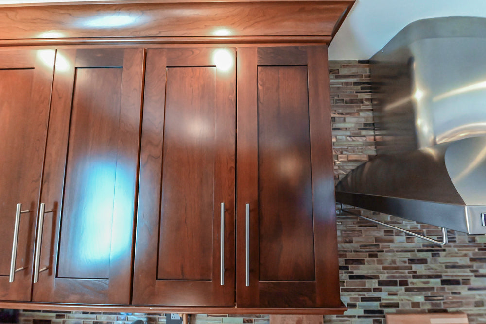 Kraftmaid Transitional Dark Wooden Kitchen with Marble Countertops and GE Monogram Appliances