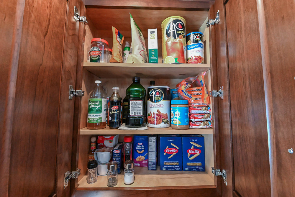 Kraftmaid Transitional Dark Wooden Kitchen with Marble Countertops and GE Monogram Appliances