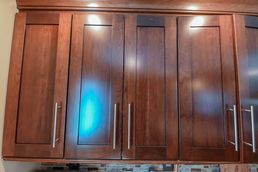Kraftmaid Transitional Dark Wooden Kitchen with Marble Countertops and GE Monogram Appliances