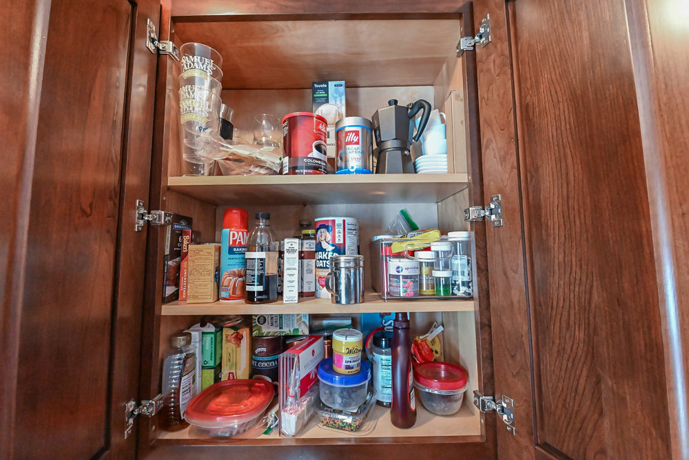 Kraftmaid Transitional Dark Wooden Kitchen with Marble Countertops and GE Monogram Appliances