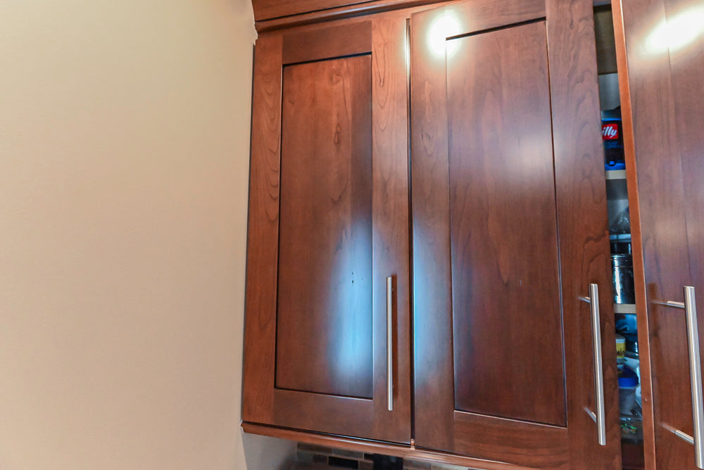 Kraftmaid Transitional Dark Wooden Kitchen with Marble Countertops and GE Monogram Appliances